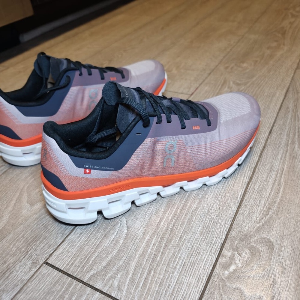On Running Sneakers in Gray, Orange, and Black